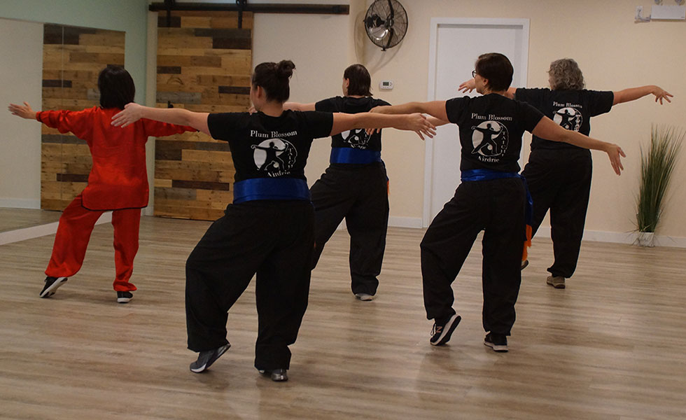 Tai Chi instructor leads students at Plum Blossom Tai Chi school in Airdrie, Alberta.